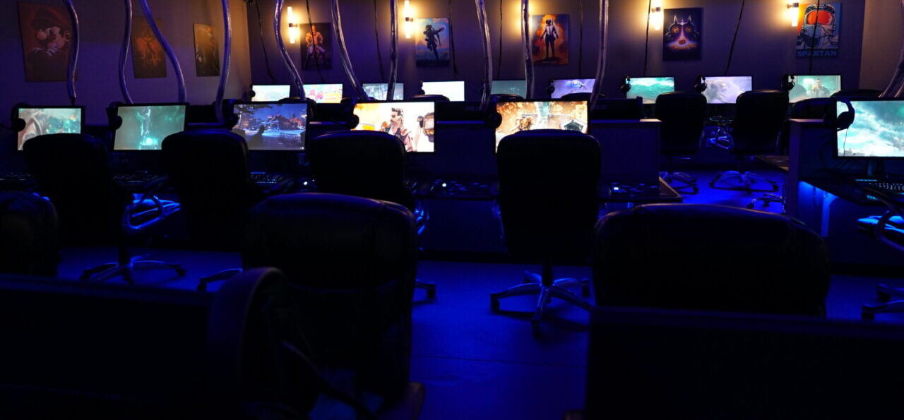 Rows of gaming PCs under blue lighting